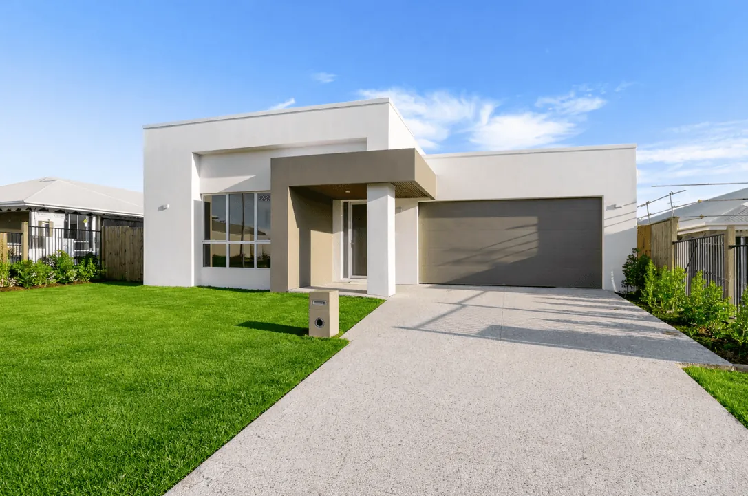 Street elevation of the Stirling Custom Home with rendered portico and grey garage door