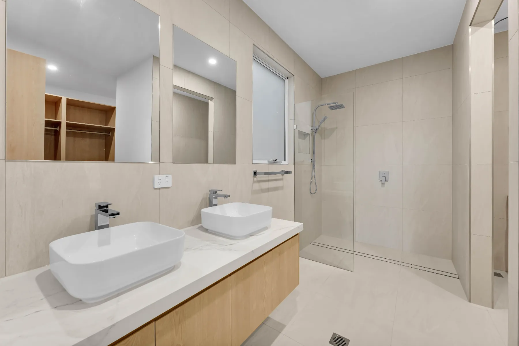 Ensuite with twin vessel basins, stone-look tiling and walk-in shower