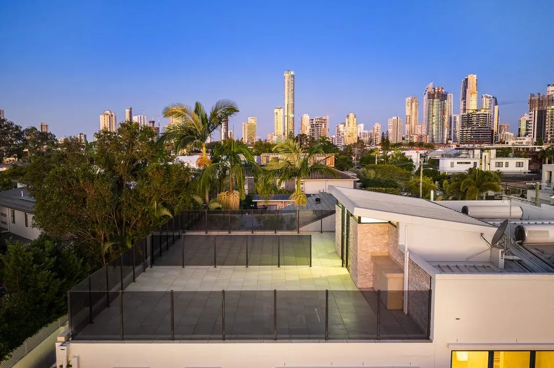 Rooftop terrace with glass balustrade looking toward the Gold Coast skyline
